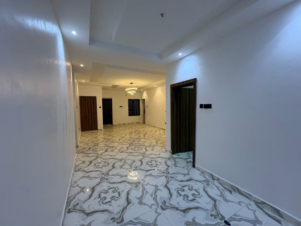 Hallway leading into the lounge with recessed lighting