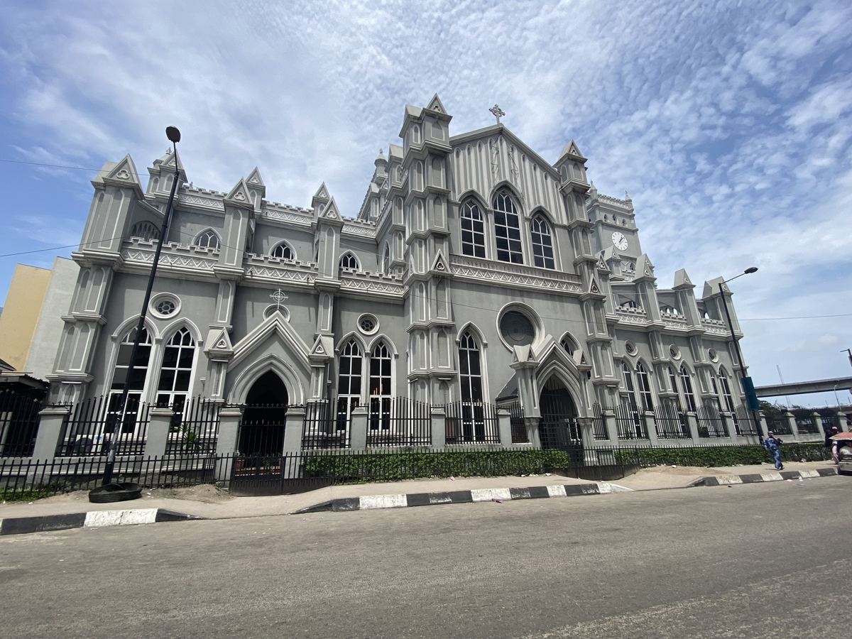 Grey Gothic cathedral facade on Lagos Island under a blue sky